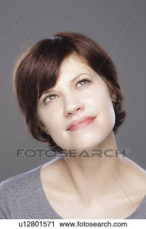Studio shot of smiling young woman View Large Photo Image Stock Image - Studio shot of smiling young woman. Fotosearch