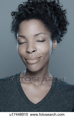 Studio shot of smiling young woman View Large Photo Image Stock Image - Studio shot of smiling young woman. Fotosearch