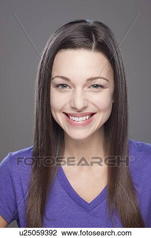 Stock Image - Studio shot of smiling young woman. Fotosearch