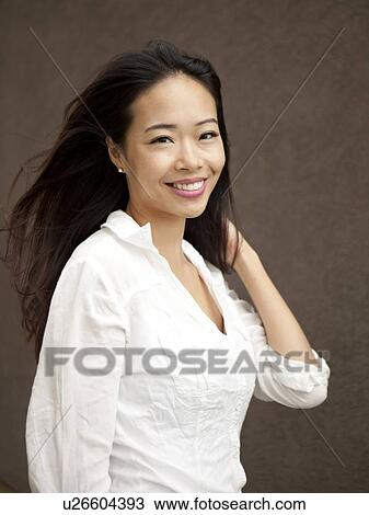 Studio shot of smiling young woman View Large Photo Image Stock Image - Studio shot of smiling young woman. Fotosearch