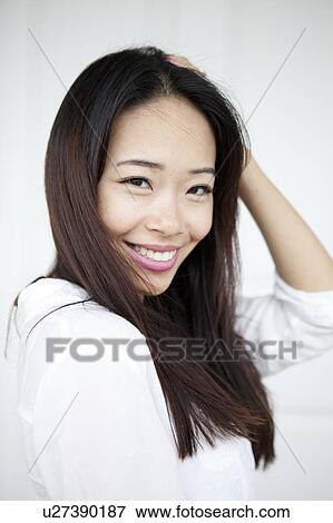 Studio shot of smiling young woman View Large Photo Image Stock Photo - Studio shot of smiling young woman. Fotosearch