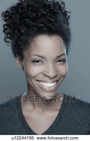 Stock Photography - Studio shot of smiling young woman. Fotosearch