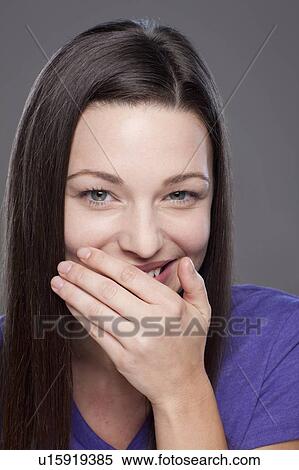 Studio shot of smiling young woman View Large Photo Image Stock Photography - Studio shot of smiling young woman. Fotosearch
