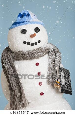 Stock Photo - Studio shot of snowman with book. Fotosearch