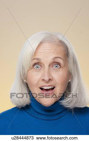 Stock Image - Studio shot of surprised senior woman. Fotosearch