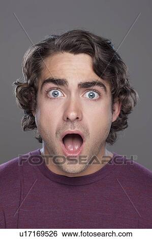 Studio shot of surprised young man View Large Photo Image Stock Photograph - Studio shot of surprised young man. Fotosearch