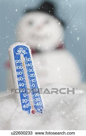 Stock Image - Studio shot of thermometer with snowman. Fotosearch