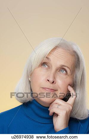 Stock Photo - Studio shot of thoughtful senior woman. Fotosearch