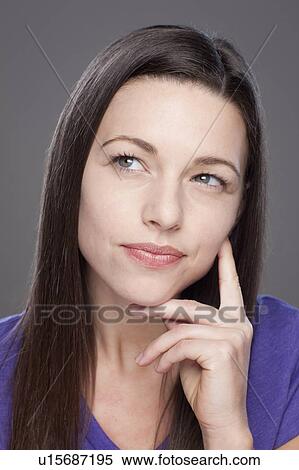 Stock Photography - Studio shot of thoughtful young woman. Fotosearch