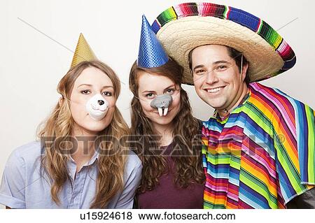 Studio Shot of three people dressed up in animal noses and sombrero View Large Photo Image Stock Photo - Studio Shot of three people dressed up in animal noses and sombrero. Fotosearch