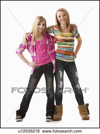 Stock Photograph - Studio shot of two happy girls (12-13). Fotosearch
