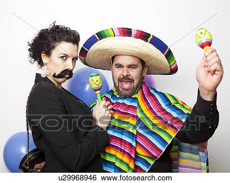 Studio Shot of two people dressed up as Mexicans View Large Photo Image Stock Photograph - Studio Shot of two people dressed up as Mexicans. Fotosearch