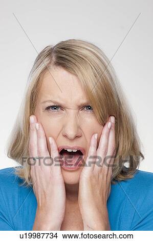 Studio shot of upset mid adult woman View Large Photo Image Picture - Studio shot of upset mid adult woman. Fotosearch