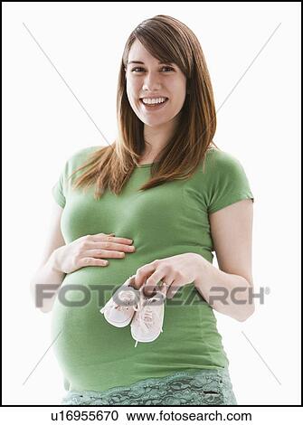 Stock Image - Studio Shot of woman holing baby booties. Fotosearch