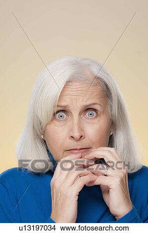 Studio shot of worried senior woman View Large Photo Image Picture - Studio shot of worried senior woman. Fotosearch