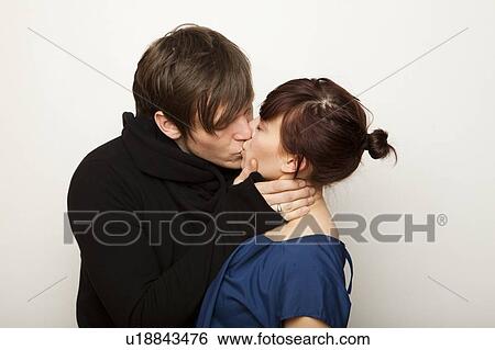 Studio Shot of young couple kissing View Large Photo Image Stock Photograph - Studio Shot of young couple kissing . Fotosearch