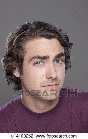 Studio shot of young man frowning forehead View Large Photo Image Stock Image - Studio shot of young man frowning forehead. Fotosearch