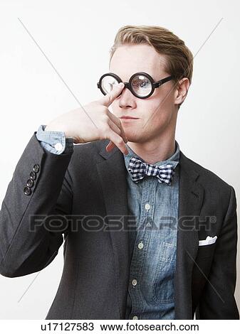 Studio shot of young man wearing funny glasses View Large Photo Image Stock Image - Studio shot of young man wearing funny glasses. Fotosearch