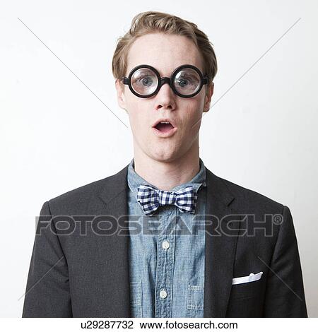 Studio shot of young man wearing funny glasses View Large Photo Image Stock Image - Studio shot of young man wearing funny glasses. Fotosearch