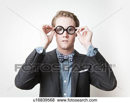 Studio shot of young man wearing funny glasses View Large Photo Image Stock Photo - Studio shot of young man wearing funny glasses. Fotosearch