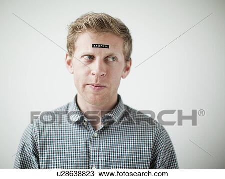 Studio shot of young man with black concept label on forehead View Large Photo Image Stock Image - Studio shot of young man with black concept label on forehead. Fotosearch