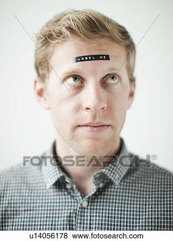 Studio shot of young man with black concept label on forehead View Large Photo Image Stock Photo - Studio shot of young man with black concept label on forehead. Fotosearch