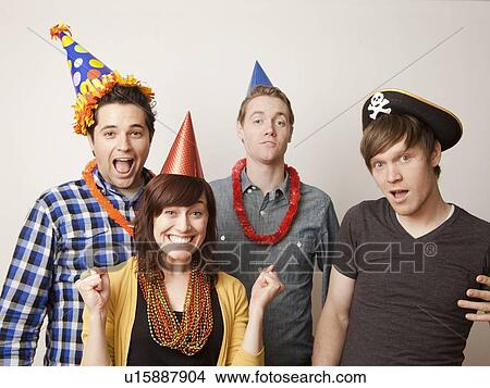 Picture - Studio Shot of young people dressed up in party hat. Fotosearch