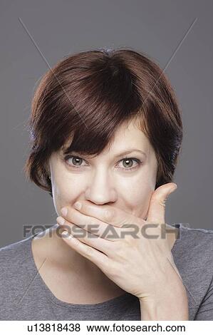 Stock Photo - Studio shot of young smiling woman. Fotosearch