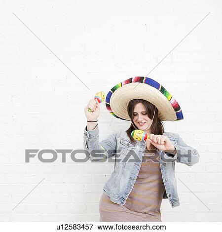 Studio Shot of young woman dancing in sombrero View Large Photo Image Stock Photo - Studio Shot of young woman dancing in sombrero. Fotosearch