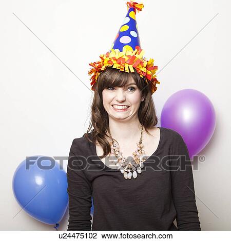 Studio Shot of young woman dressed in party hat View Large Photo Image Stock Image - Studio Shot of young woman dressed in party hat. Fotosearch
