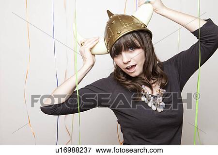 Stock Photo - Studio Shot of young woman in Viking Helmet. Fotosearch