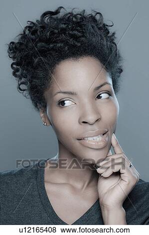 Stock Photo - Studio shot of young woman smiling. Fotosearch