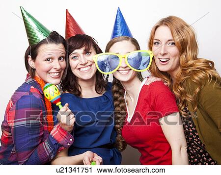 Stock Image - Studio Shot of young women dressed in party hat. Fotosearch
