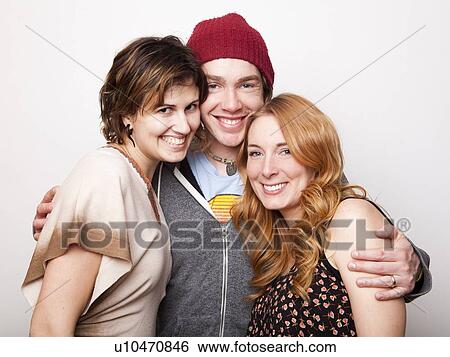 Studio Shot portrait of three people smiling View Large Photo Image Stock Photograph - Studio Shot portrait of three people smiling. Fotosearch