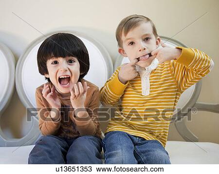 Studio Shot portrait of two boys (4-5, 6-7) sitting side by side View Large Photo Image Stock Image - Studio Shot portrait of two boys (4-5, 6-7) sitting side by side. Fotosearch