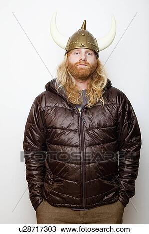 Stock Image - Studio Shot portrait of young man in Viking Helmet. Fotosearch
