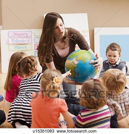 Teacher with children (2-3, 4-5) learning geography View Large Photo Image Stock Image - Teacher with children (2-3, 4-5) learning geography. Fotosearch