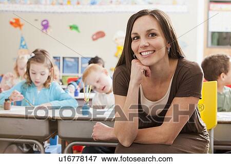 Teacher with children (4-5, 6-7) during art classes View Large Photo Image Stock Photo - Teacher with children (4-5, 6-7) during art classes. Fotosearch