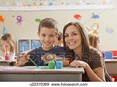 Stock Photo - Teacher with children (4-5, 6-7) during art classes. Fotosearch