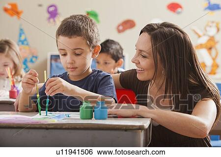 Stock Photograph - Teacher with children (4-5, 6-7) during art classes. Fotosearch