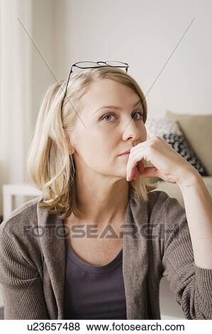 Thoughtful mid adult woman looking away View Large Photo Image Stock Photo - Thoughtful mid adult woman looking away. Fotosearch
