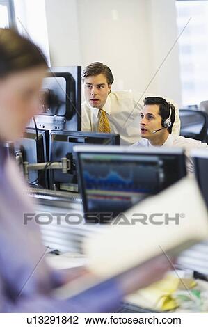 Traders at trading desk View Large Photo Image Stock Image - Traders at trading desk. Fotosearch