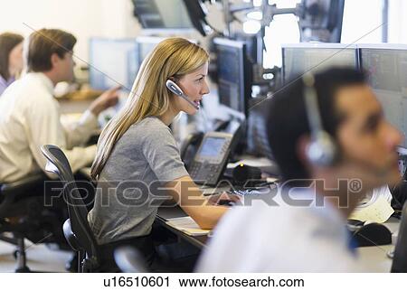 Stock Image - Traders at trading desk. Fotosearch