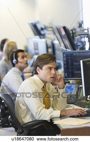 Traders at trading desk View Large Photo Image Stock Image - Traders at trading desk. Fotosearch