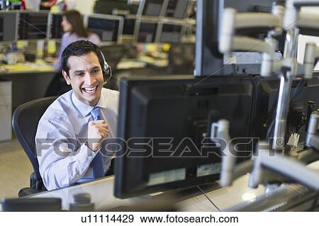 Stock Photo - Traders at trading desk. Fotosearch