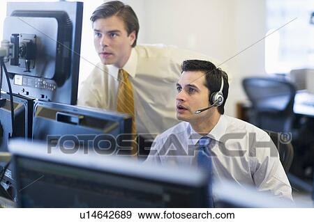 Traders at trading desk View Large Photo Image Stock Photo - Traders at trading desk. Fotosearch