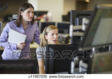 Stock Photography - Traders at trading desk. Fotosearch