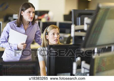 Stock Photography - Traders at trading desk. Fotosearch