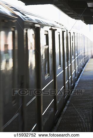 Stock Image - Train on platform. Fotosearch