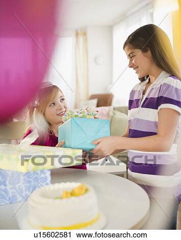 Stock Image - Two girls celebrating birthday. Fotosearch